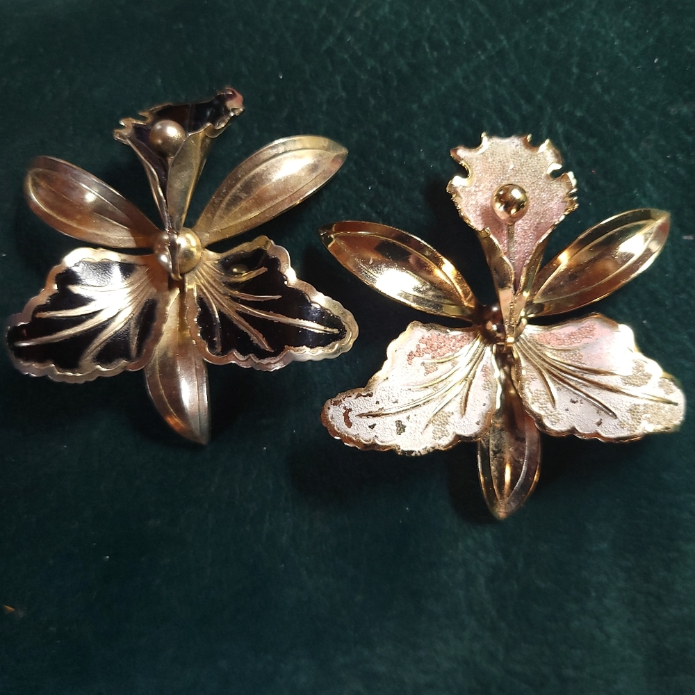 Goldtone black and sparkling white and pink orchid brooches. $25 each